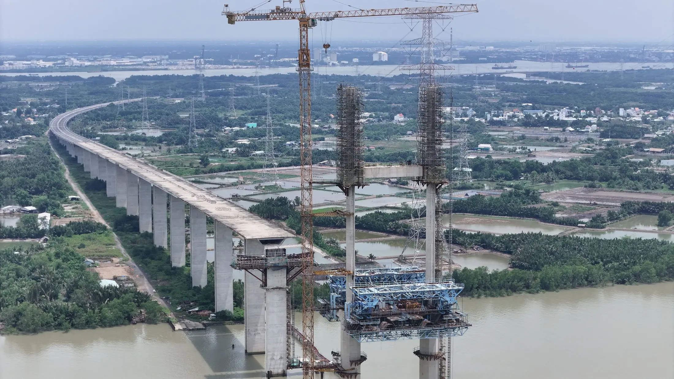 Aerial view of a bridge under construction over a waterway, used as a representative image