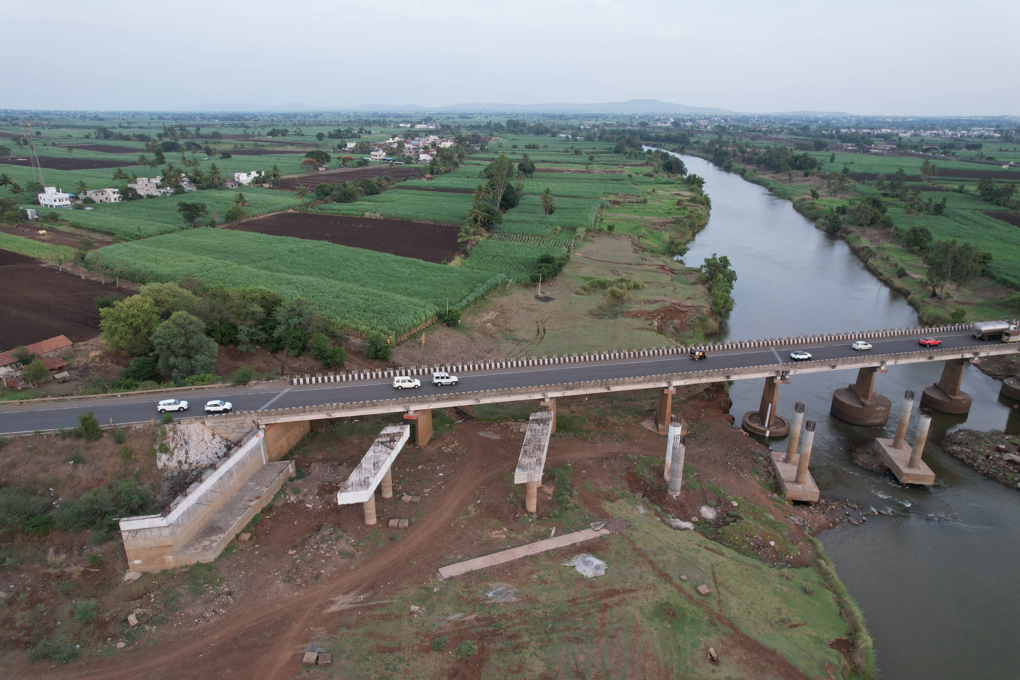 Bridge piers and girders beside the existing river crossing