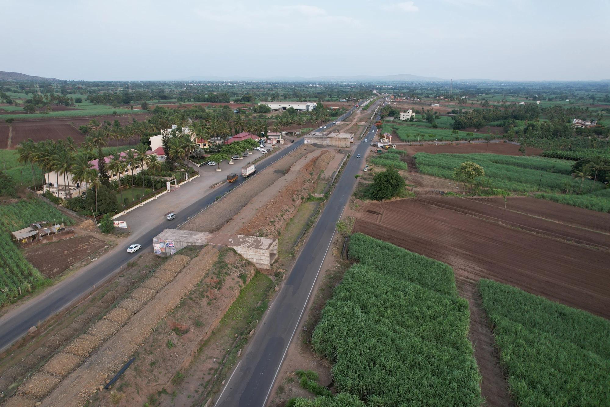 The highway alignment between agricultural fields